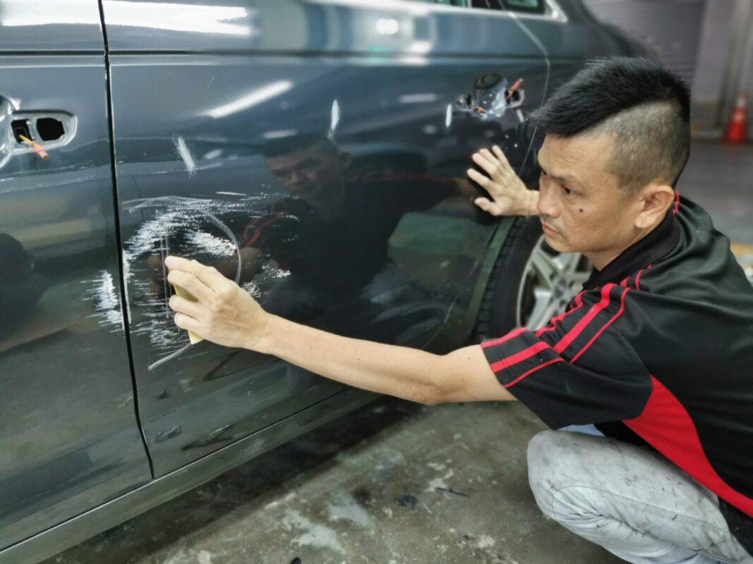 Surface of the Audi A4 being inspected and checked for imperfections on Day 3.