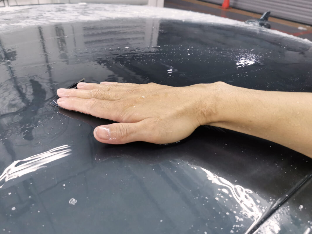 A Revol Carz technician sanding a body panel on the Audi A4 on Day 4.