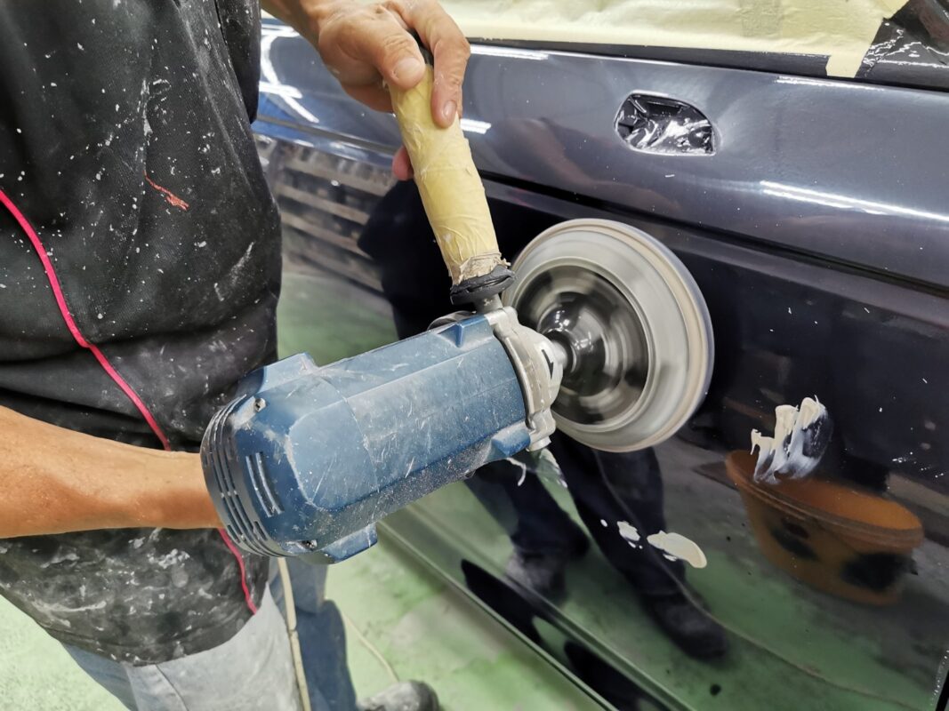 Machine-polishing the Audi A4 on Day 6 to bring up the gloss after painting.