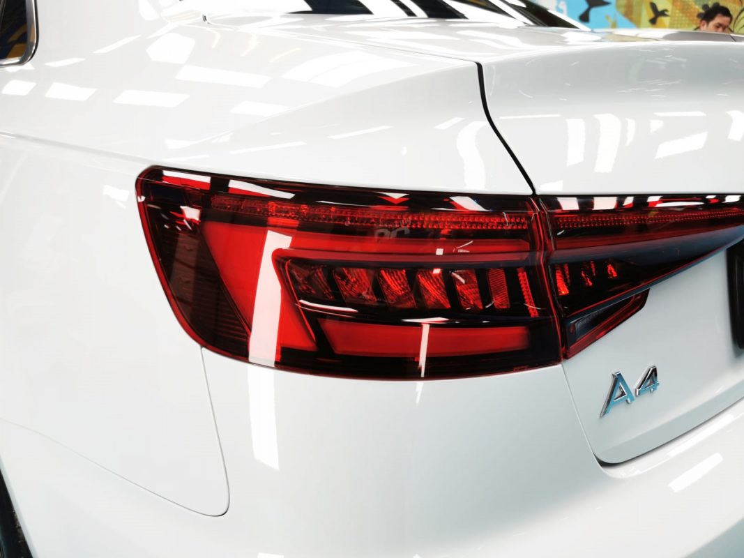 The coated bonnet of the A4 under workshop lighting.