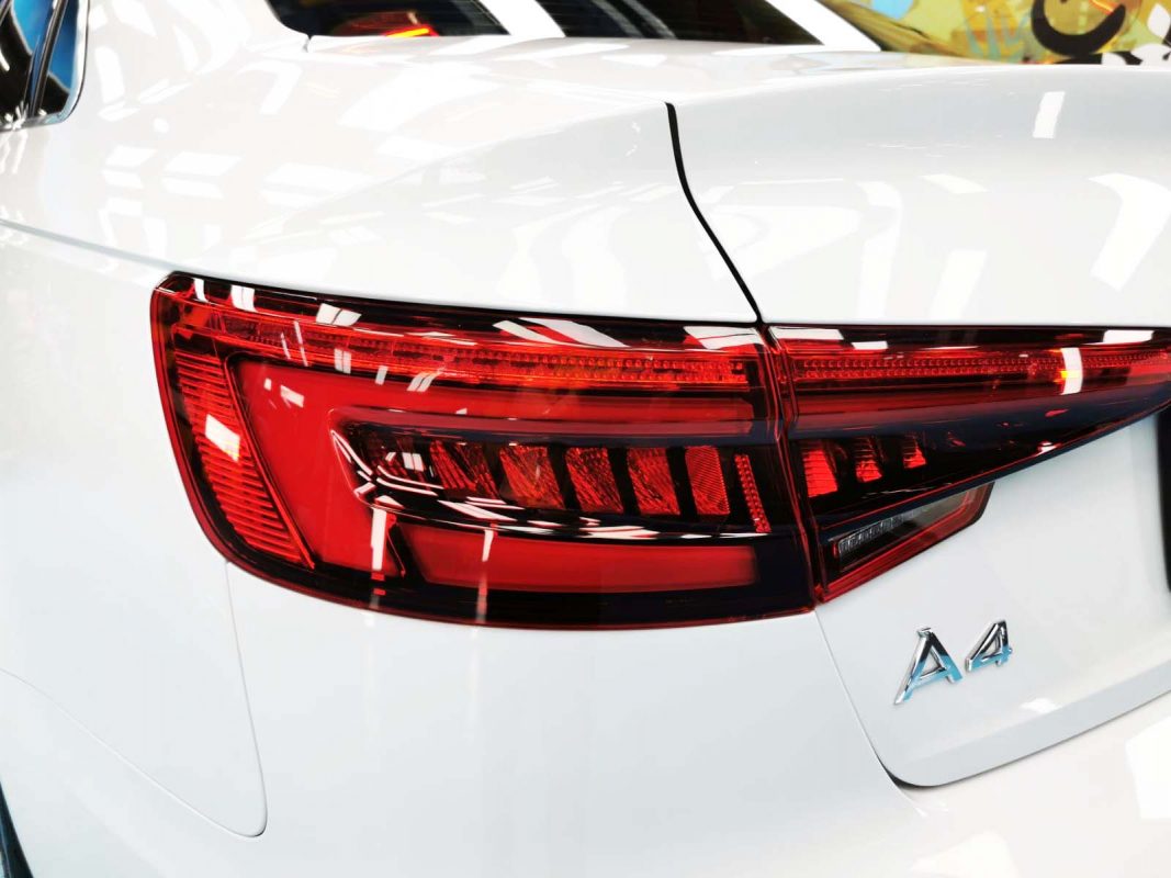 The coated bonnet of the A4 under workshop lighting.