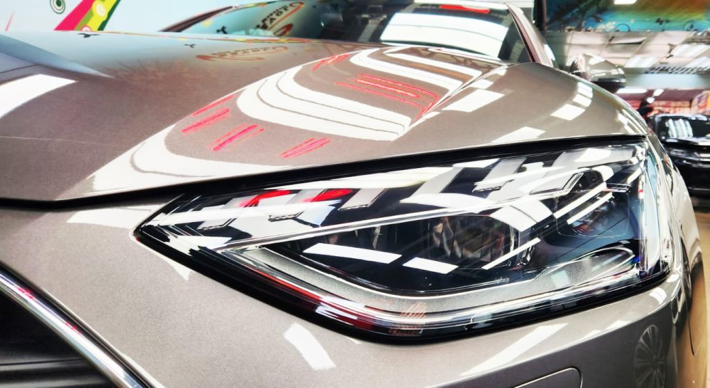 The A4's coated paintwork holding clean reflections.