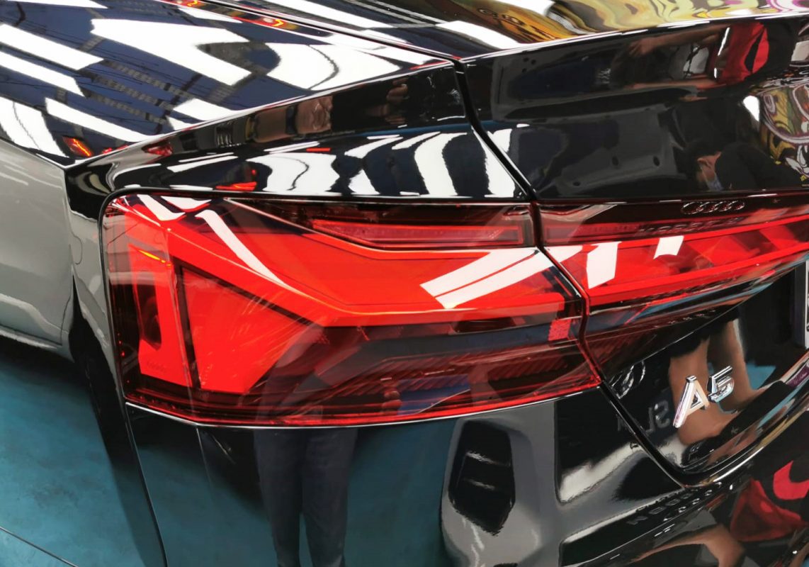 The coated bonnet of the Audi A5 Cabrio under workshop lighting.
