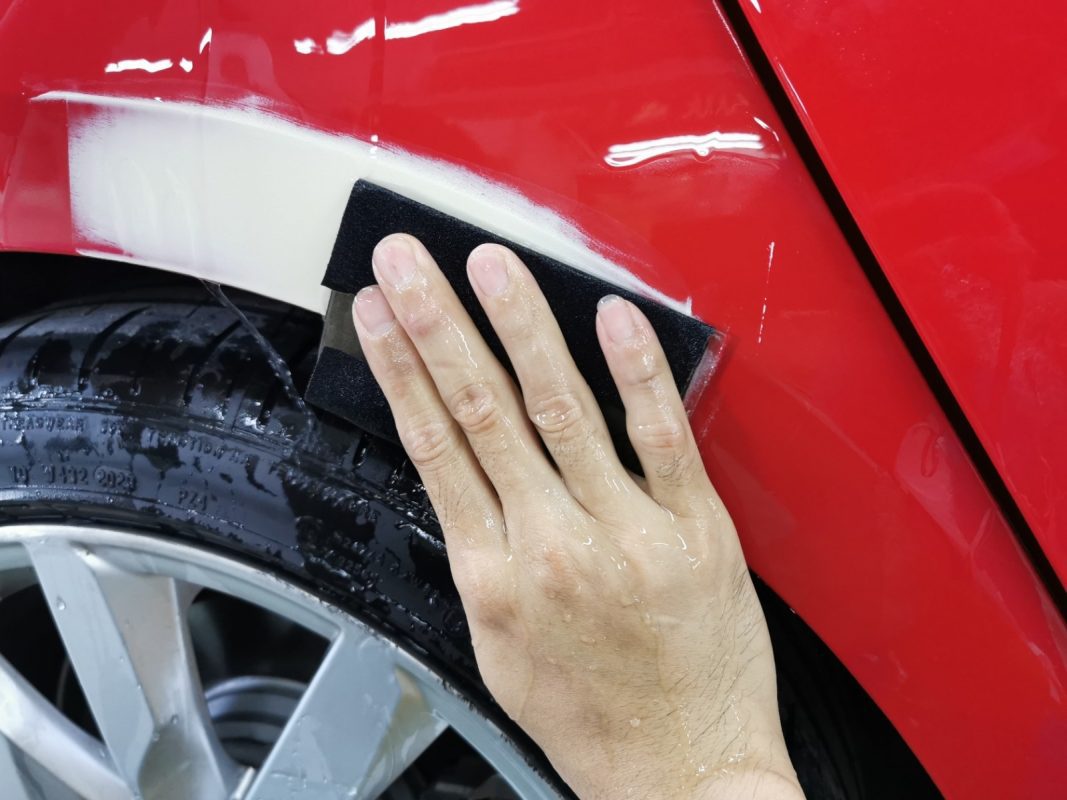 Wet-sanding the A5's panels to smooth the existing paintwork.