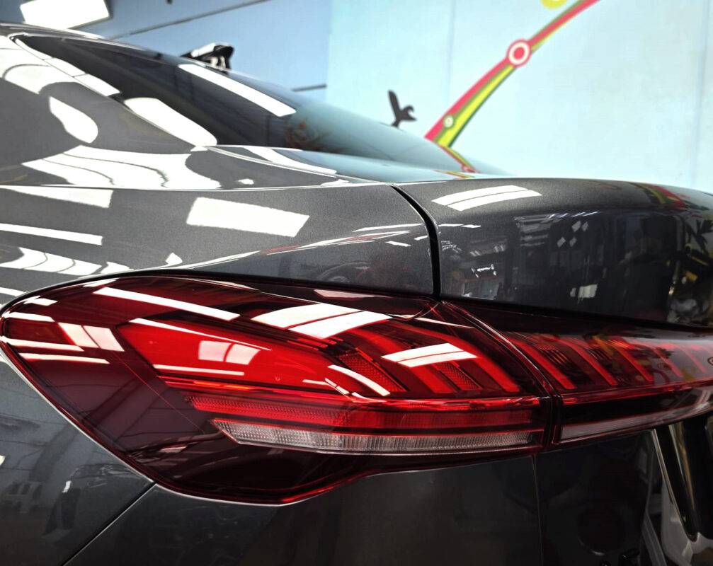The coated bonnet of the Audi A5 under workshop lighting.