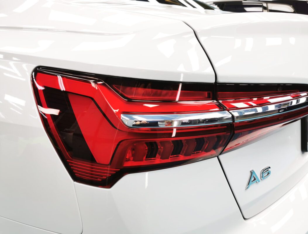 The coated bonnet of the Audi A6 under workshop lighting.