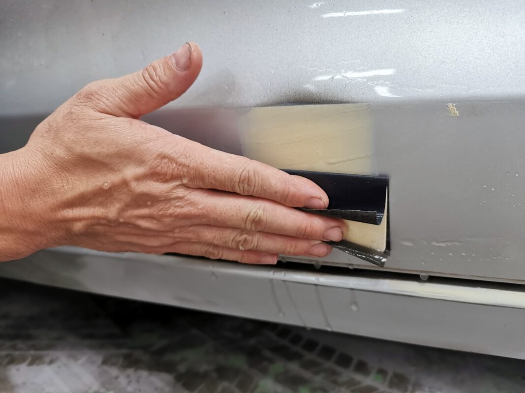 Continued wet-sanding of the Audi A6 panels, working towards a uniform finish.