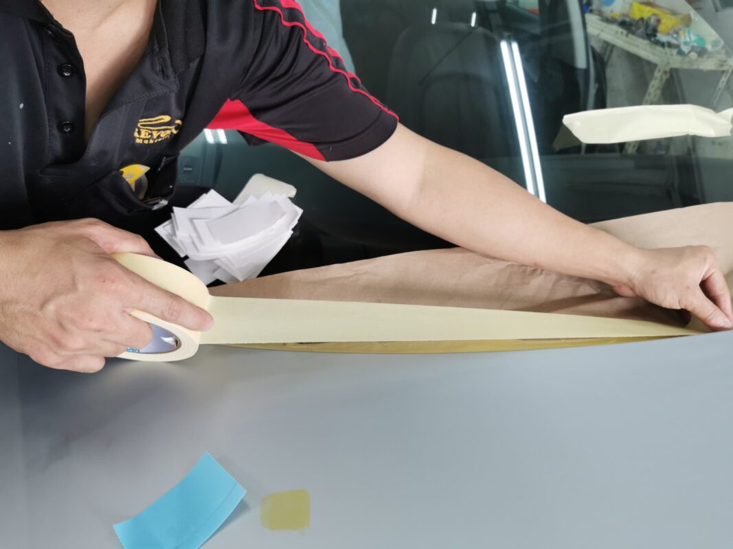 Non-painted surfaces on the Audi A6 carefully masked before the spray booth.