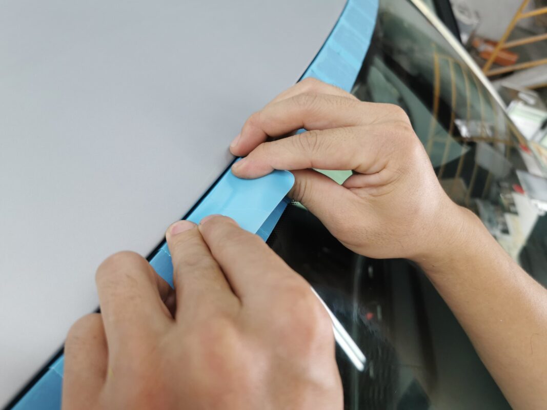 Detailed masking of the Audi A6 trim and edges before spraying.