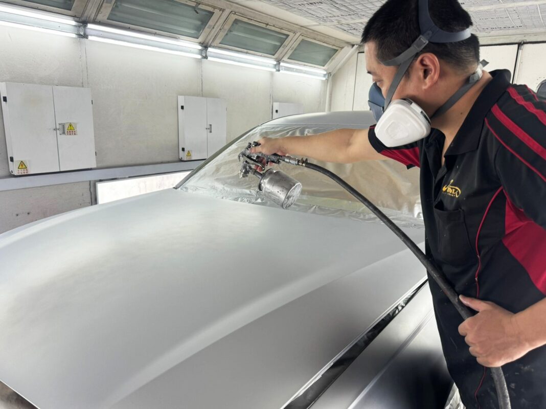 The Audi A6 in the spray booth, fresh coat being applied.