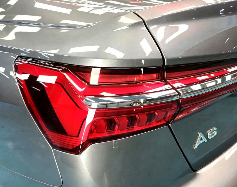 Close-up of the red tail light and A6 badge on the grey boot lid.