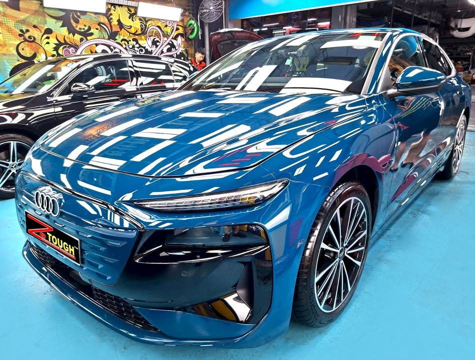 Blue Audi A6 front three-quarter view in the Revol Carz workshop after ZeTough Titanium coating.