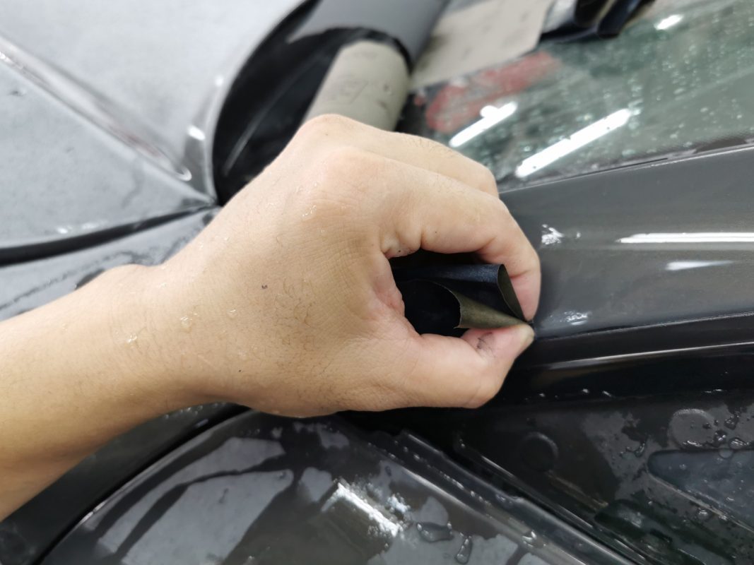 Wet-sanding the A7's panels to smooth the existing paintwork.