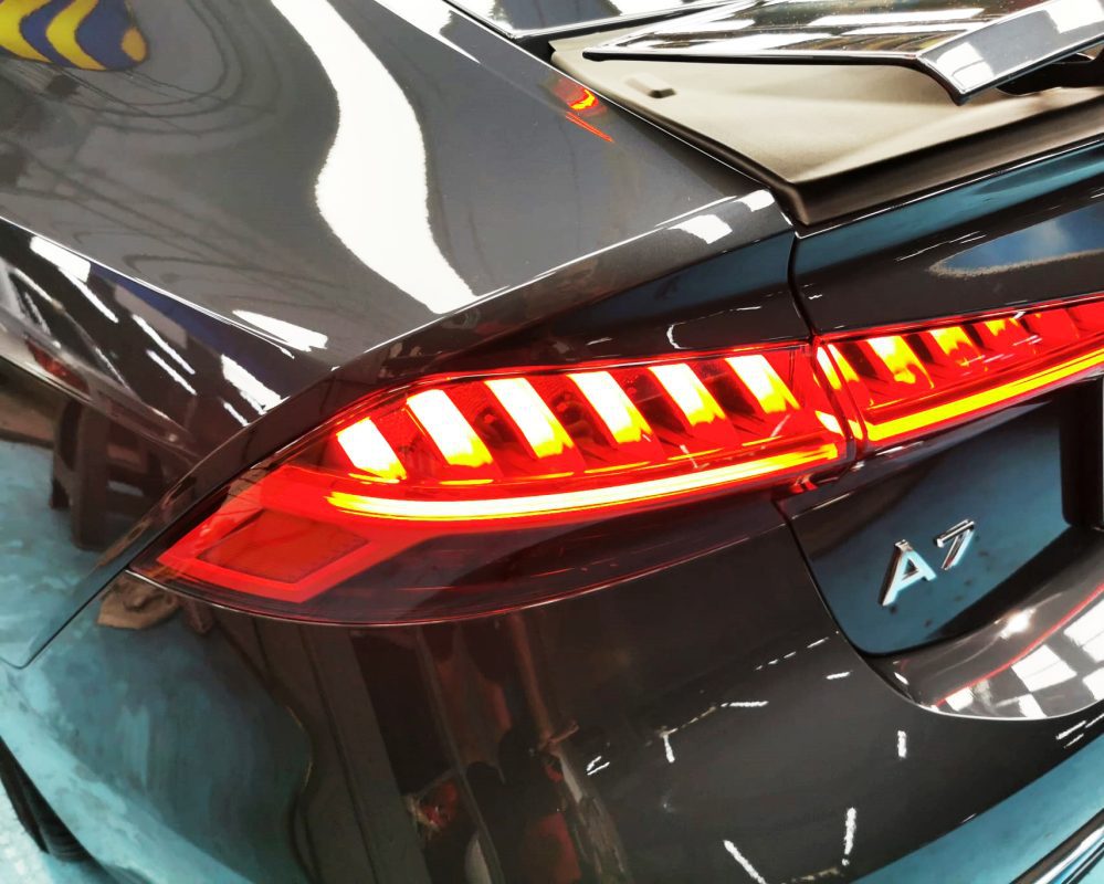 The coated bonnet of the Audi A7 under workshop lighting.