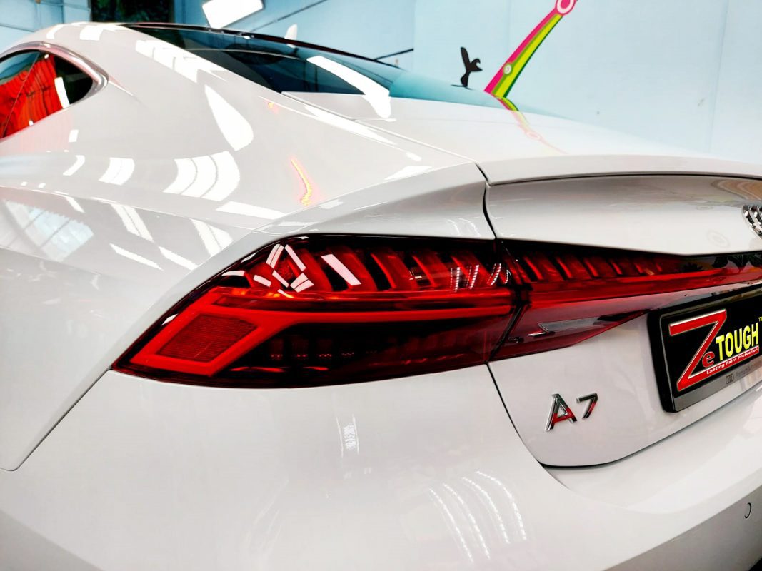 The coated bonnet of the Audi A7 under workshop lighting.
