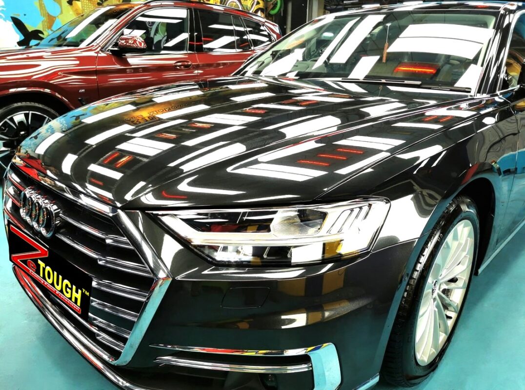 The Audi A8's coated paintwork under workshop lighting.