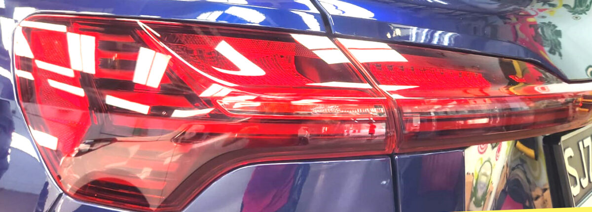 The coated bonnet of the Audi e-tron under workshop lighting.