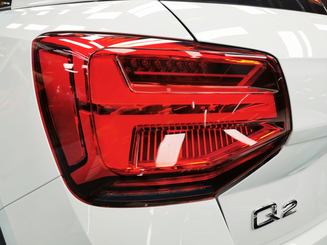 The coated bonnet of the Audi Q2 under workshop lighting.