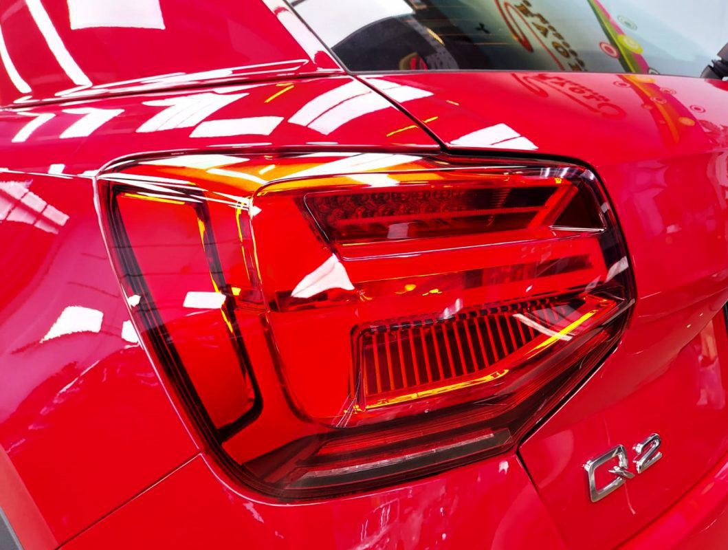 The coated bonnet of the Audi Q2 under workshop lighting.