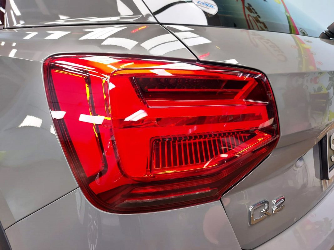 The coated bonnet of the Audi Q2 under workshop lighting.