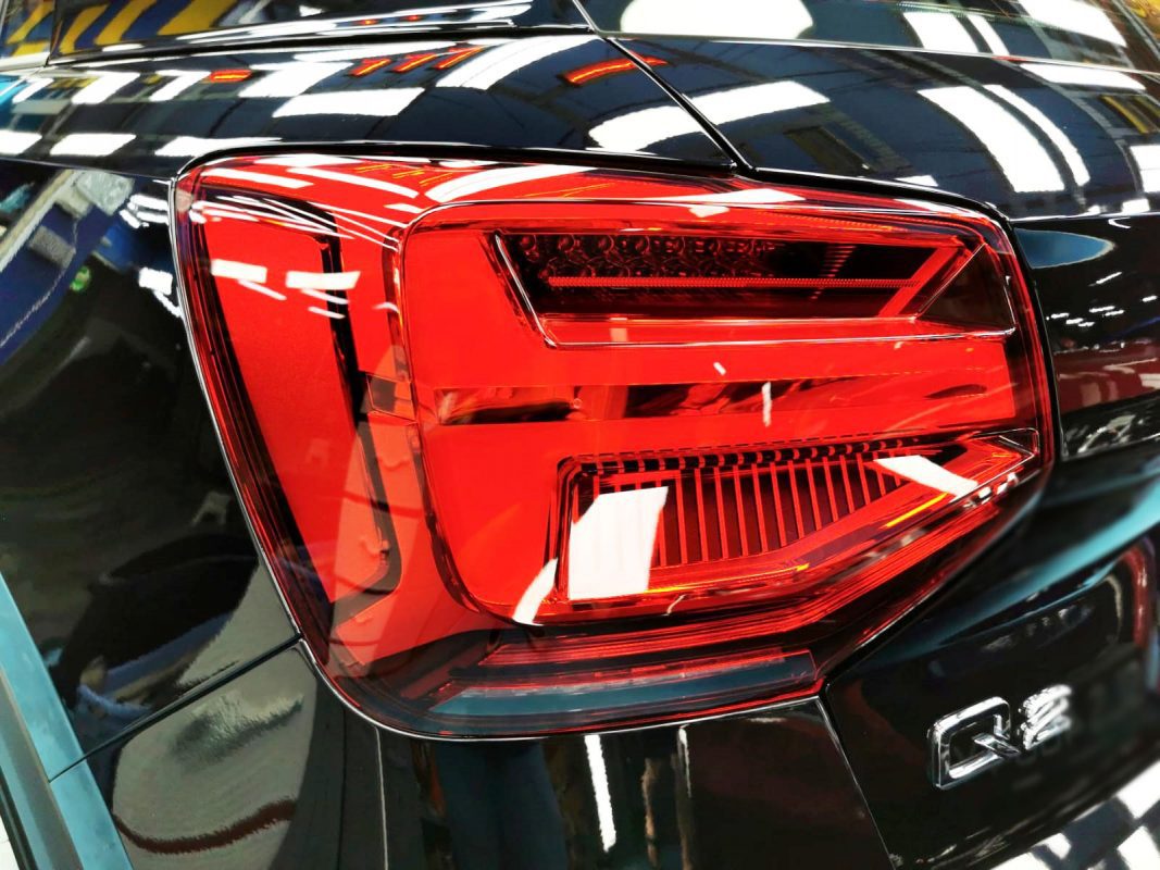 The coated bonnet of the Audi Q2 under workshop lighting.