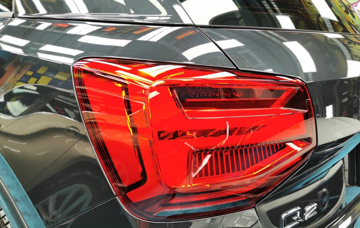 The coated bonnet of the Audi Q2 under workshop lighting.