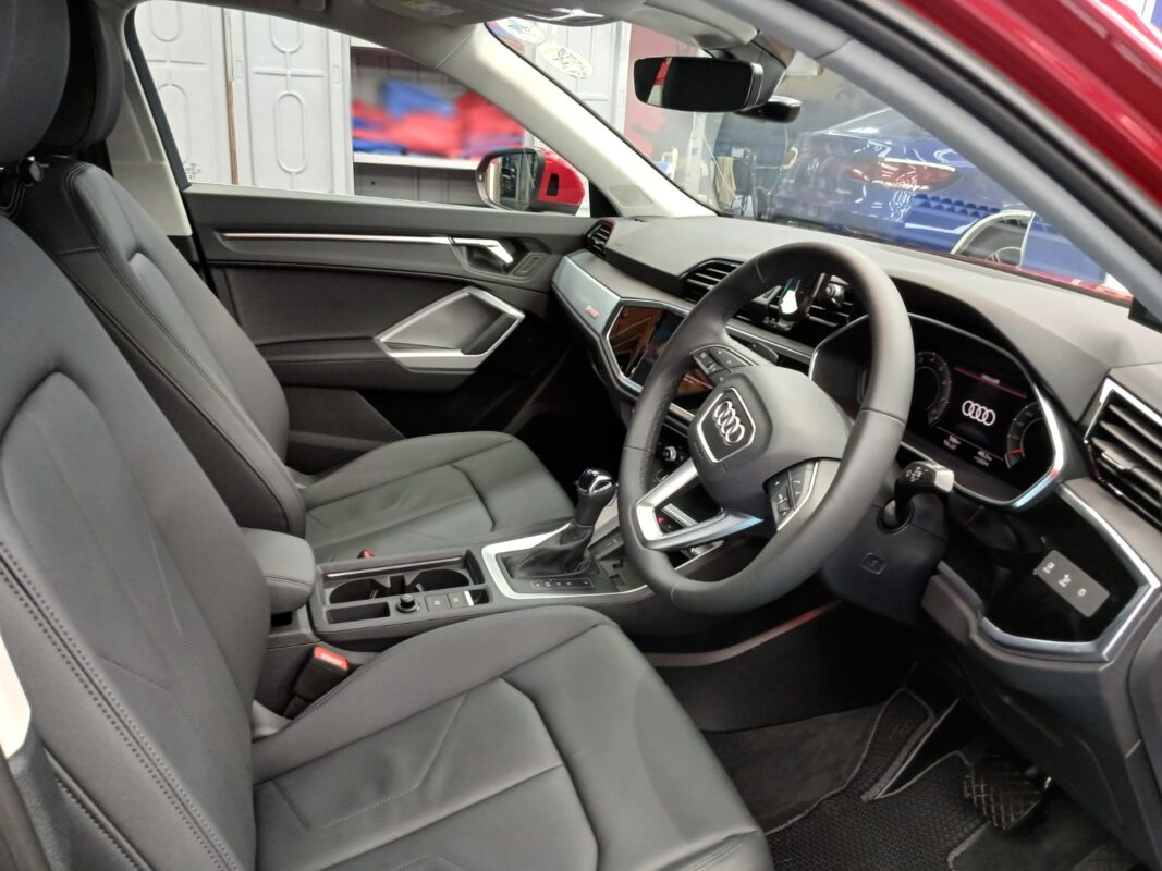 The Audi Q3 parked in the workshop, freshly coated.