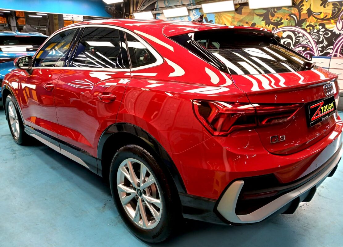 Rear quarter of the Audi Q3, glossy and protected.