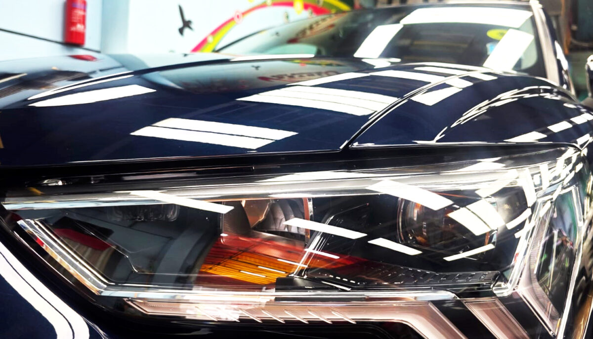 The Audi Q3's coated paintwork showing clean reflections.