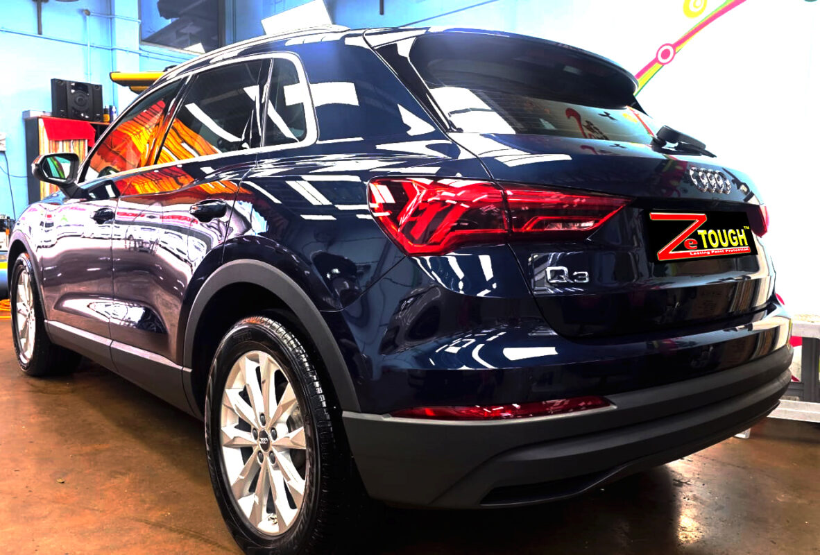 Rear quarter of the Audi Q3, glossy and protected.