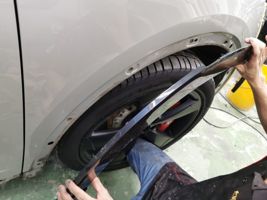 The Audi Q3 partially dismantled, panels and trim removed for the respray.