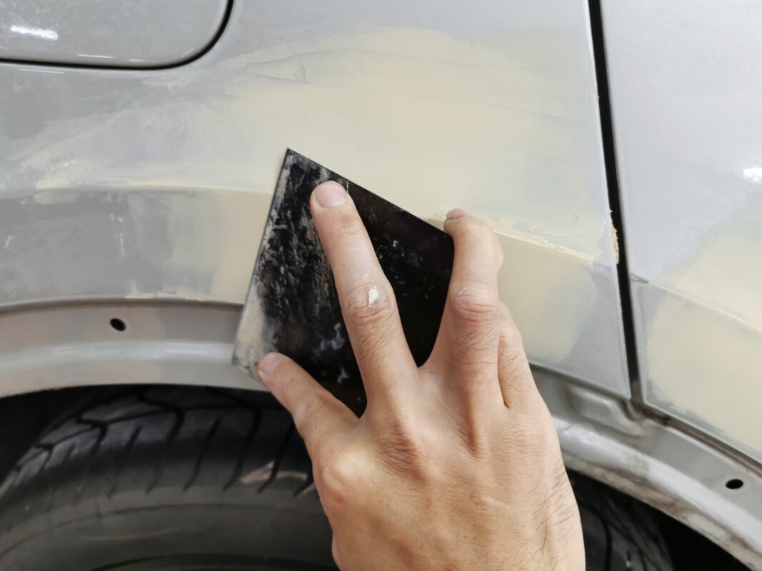 The Audi Q3 surface being inspected and marked for repair before bodywork.