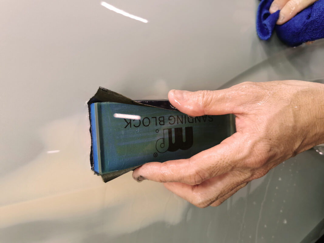 A panel on the Audi Q3 after sanding, surface ready for priming.