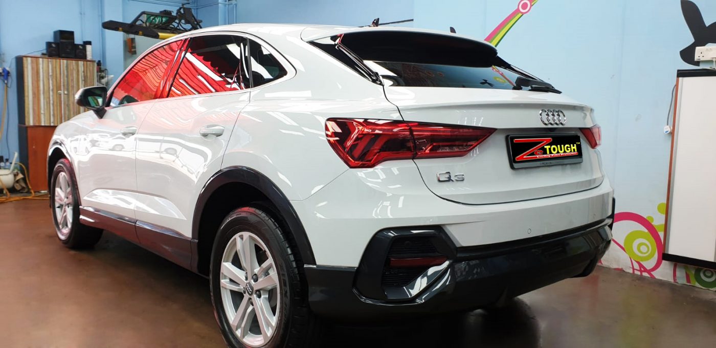 Rear quarter of the Audi Q3, glossy and protected.