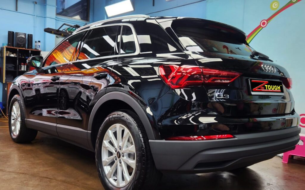 Rear quarter of the Audi Q3, glossy and protected.
