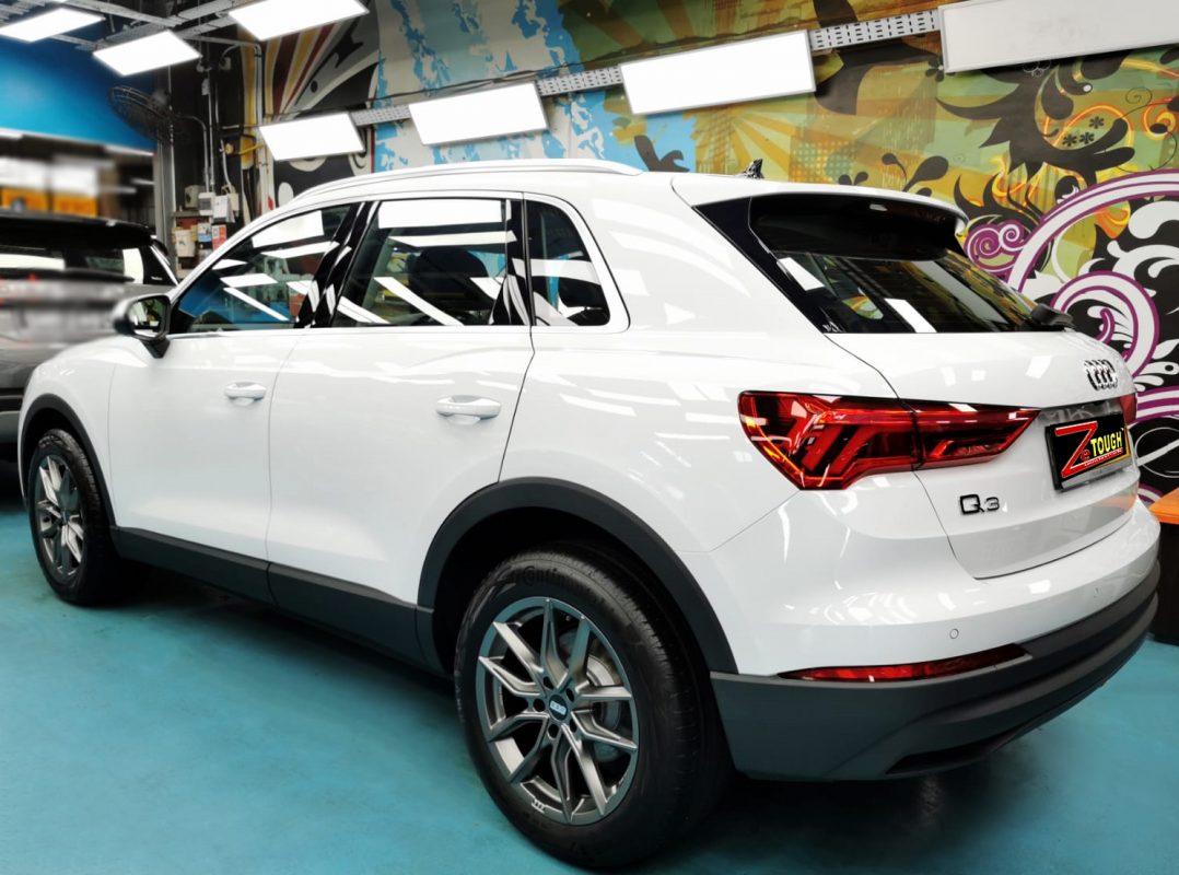 Rear quarter of the Audi Q3, glossy and protected.
