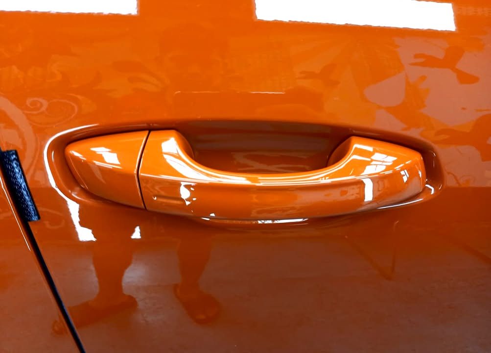 Close-up of the orange door handle and panel.
