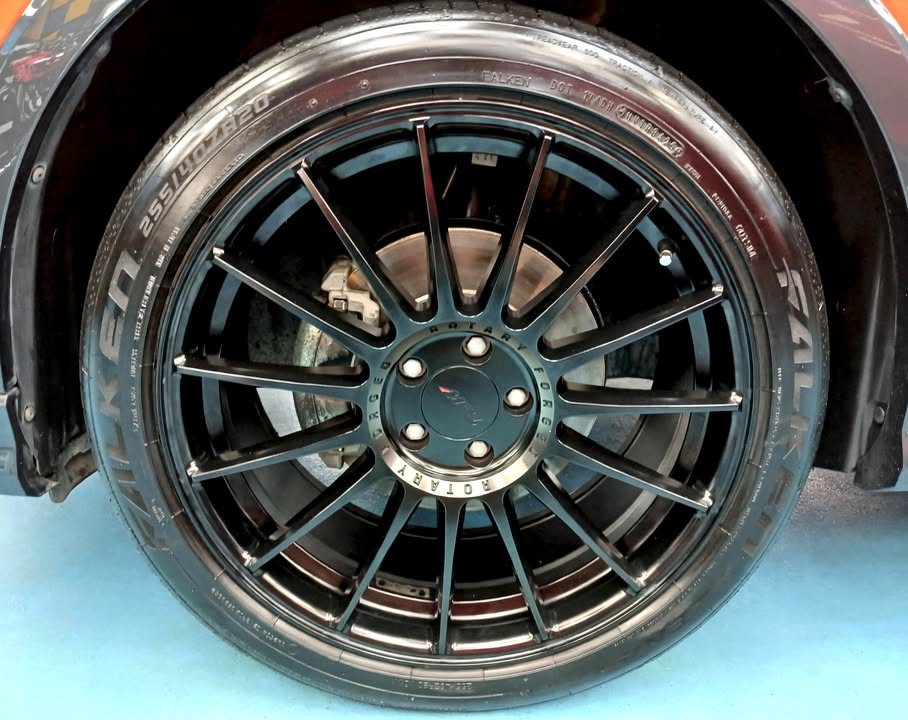 Close-up of the black multi-spoke alloy wheel.