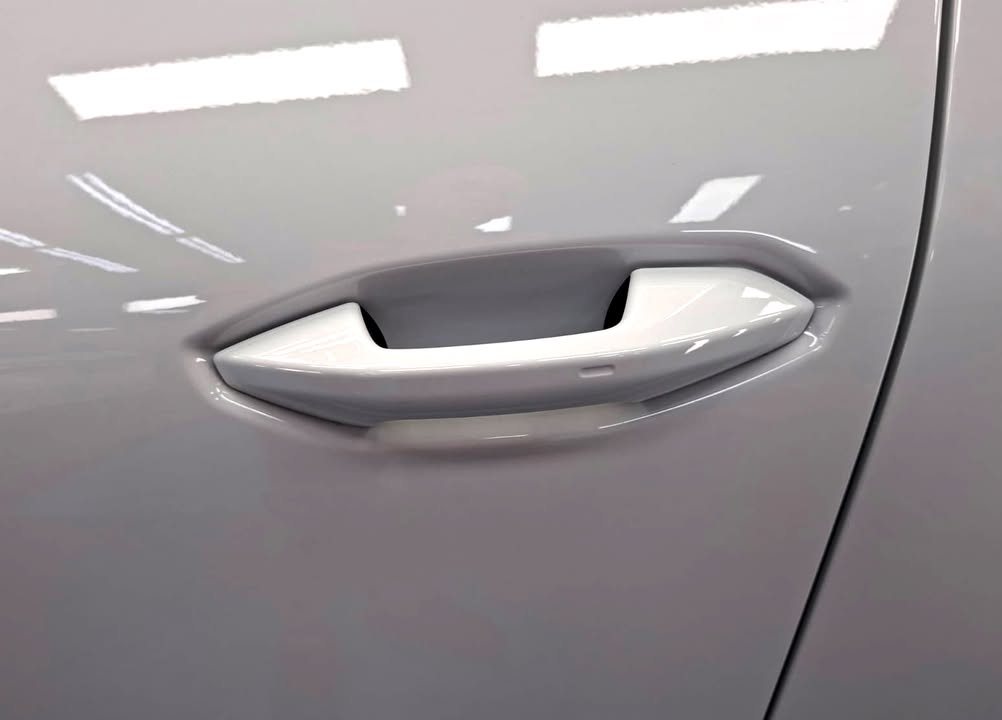 White door handle and door panel with a glossy finish.