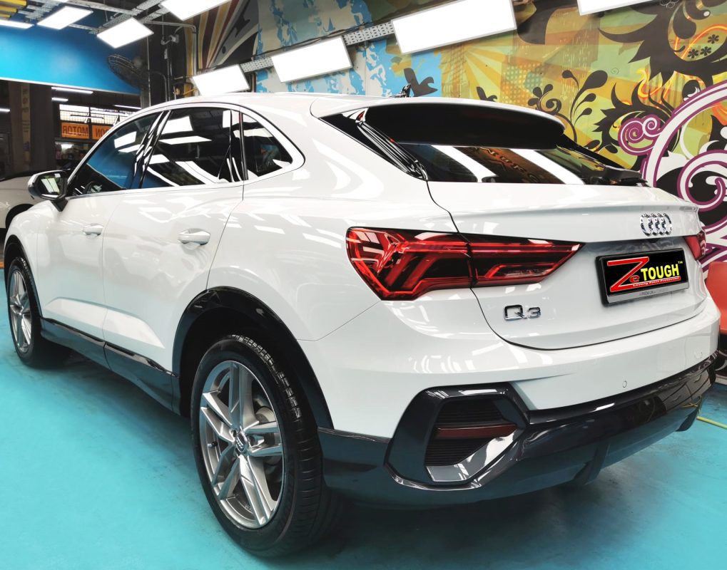 Rear quarter of the Audi Q3, glossy and protected.