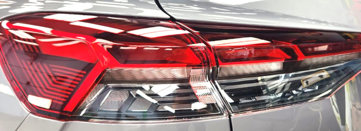 The coated bonnet of the Audi Q4 under workshop lighting.