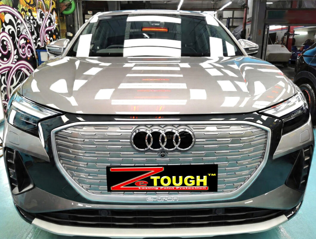 The Audi Q4's coated paintwork under workshop lighting.