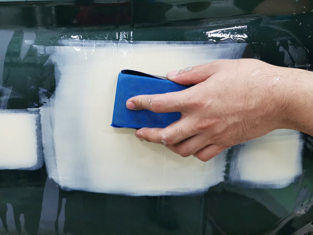 Wet-sanding the whole surface of the Q5 in preparation for spraying.
