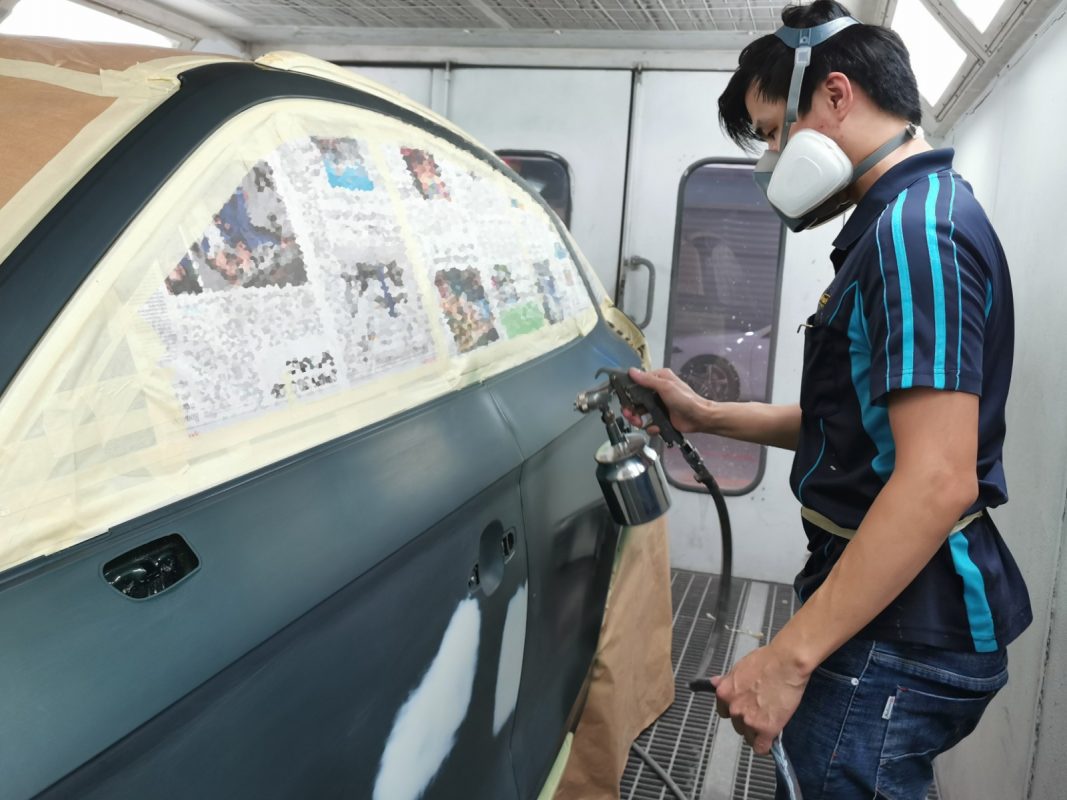 The Q5 being wet-sanded after spraying for an even surface.