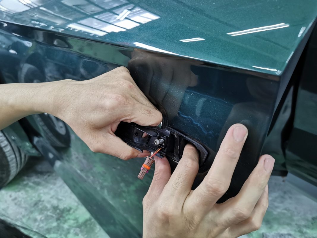Previously removed car parts being refitted onto the Q5.