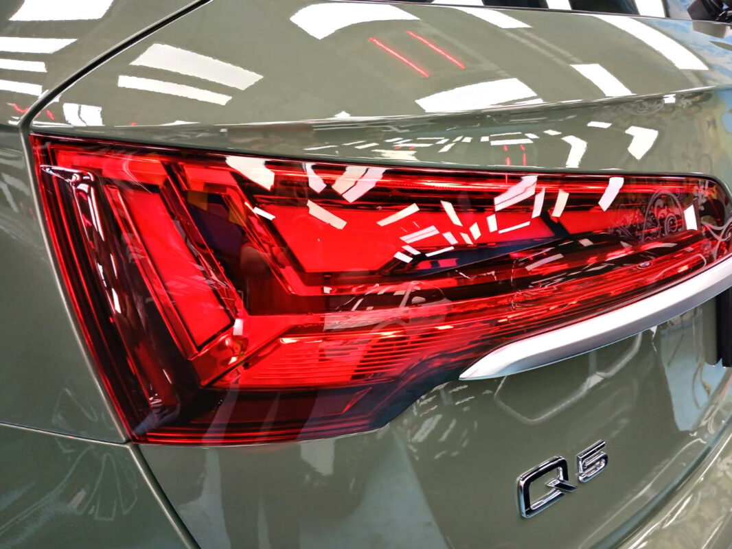 The coated bonnet of the Audi Q5 under workshop lighting.