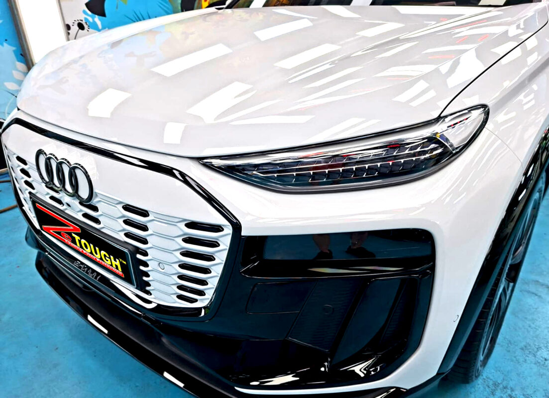 The Audi Q6 e-tron's coated paintwork under workshop lighting.