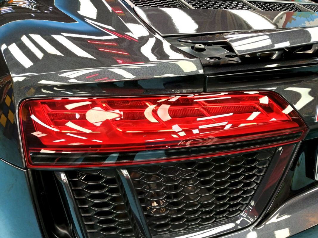 The coated bonnet of the Audi R8 under workshop lighting.