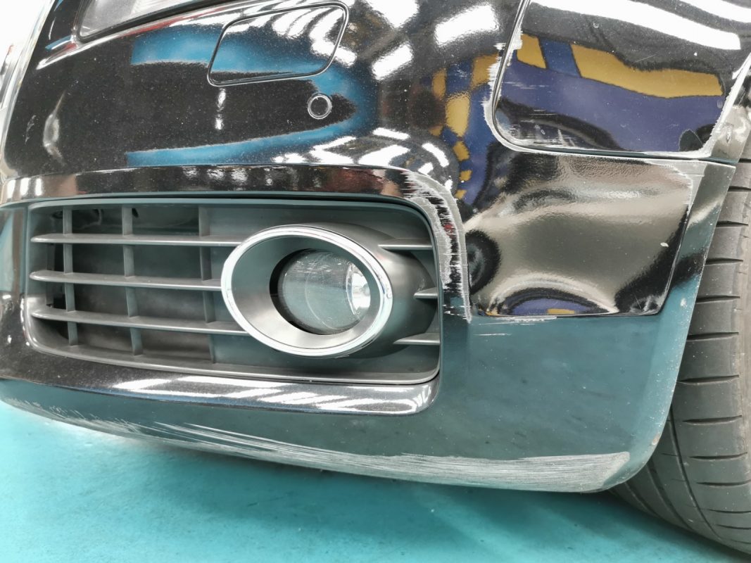 The Audi S5 at intake, showing scratches and damage on the body.