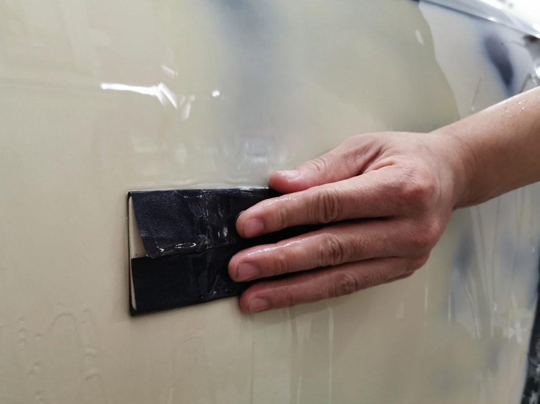 Wet-sanding the S5's panels to smooth the surface.